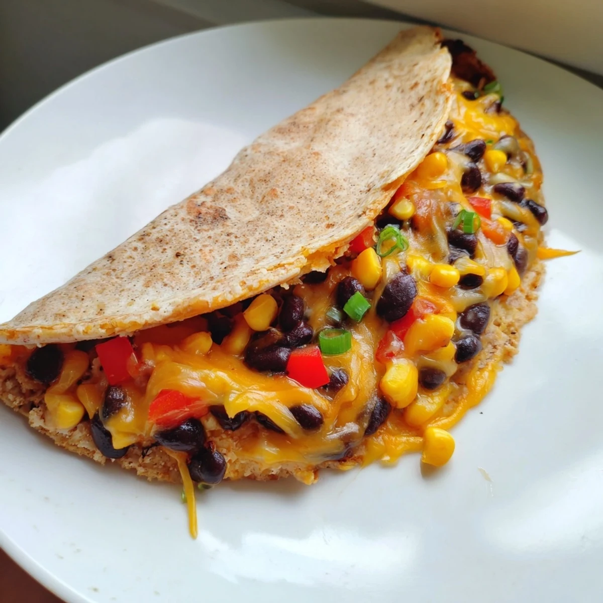 Crispy, folded flour tortillas filled with bubbly cheese, plus flavorful black beans and corn—the quick quesadillas.