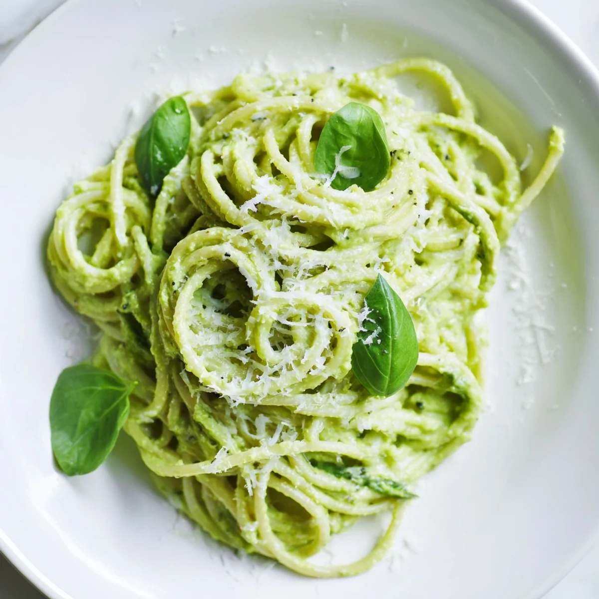 A bowl of fresh, bright creamy avocado pasta, perfect for a quick and satisfying vegetarian meal.