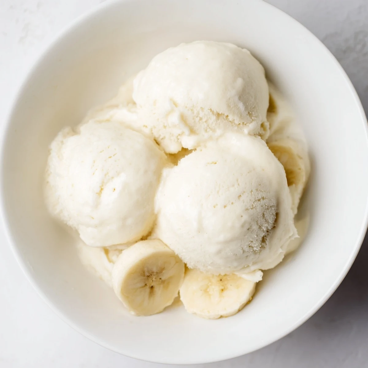 Creamy 2-Ingredient Banana Ice Cream, a cool and refreshing dairy-free dessert, served in a bowl.