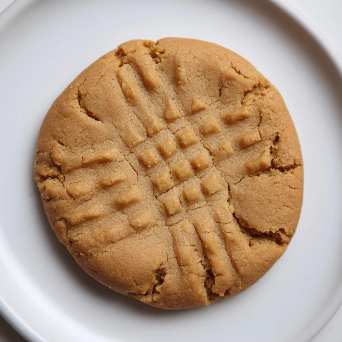 Close-up of perfectly textured flourless peanut butter cookies, a simple gluten-free recipe.