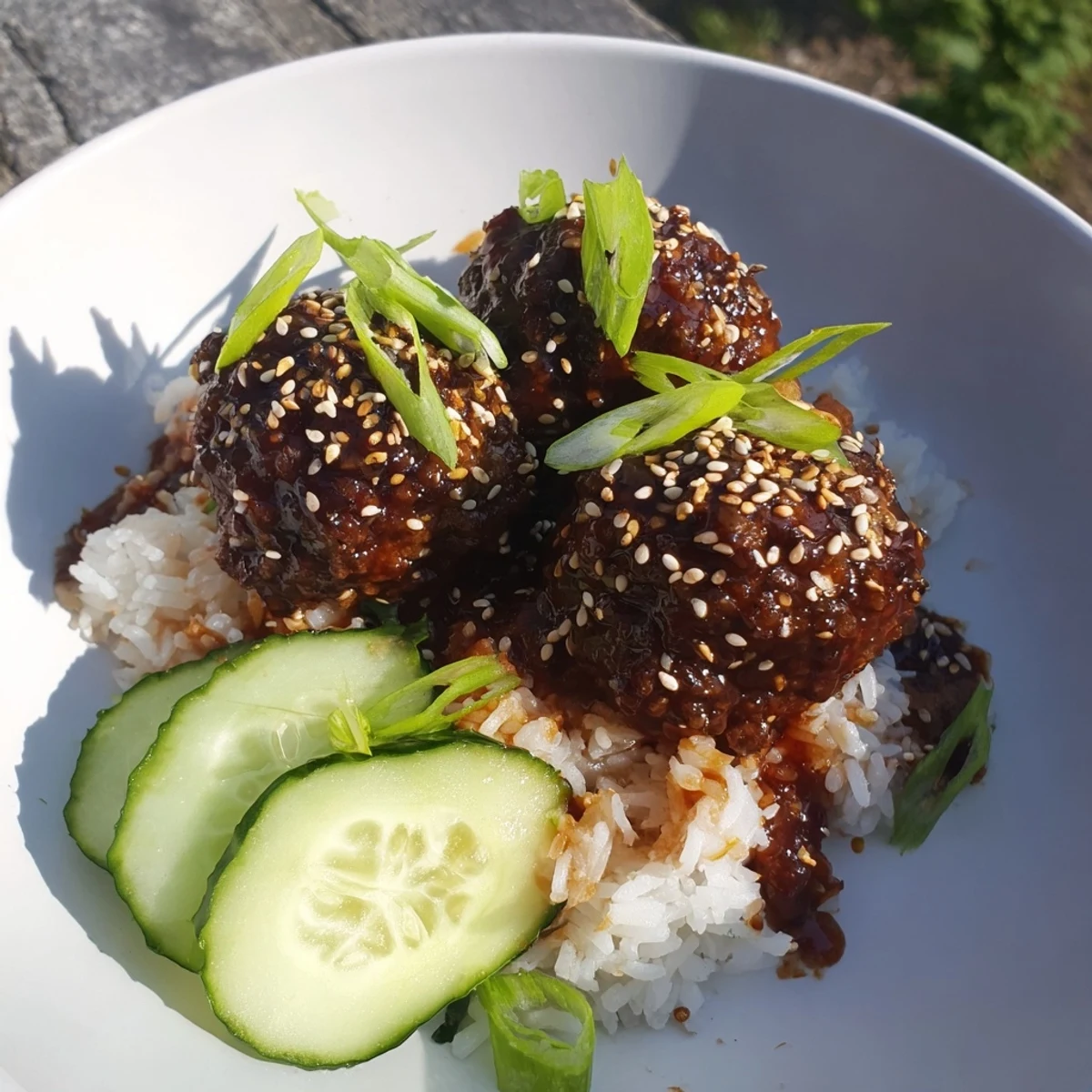 Flavorful teriyaki meatball bowls showcasing juicy meatballs smothered in a rich, sweet sauce and served with rice.