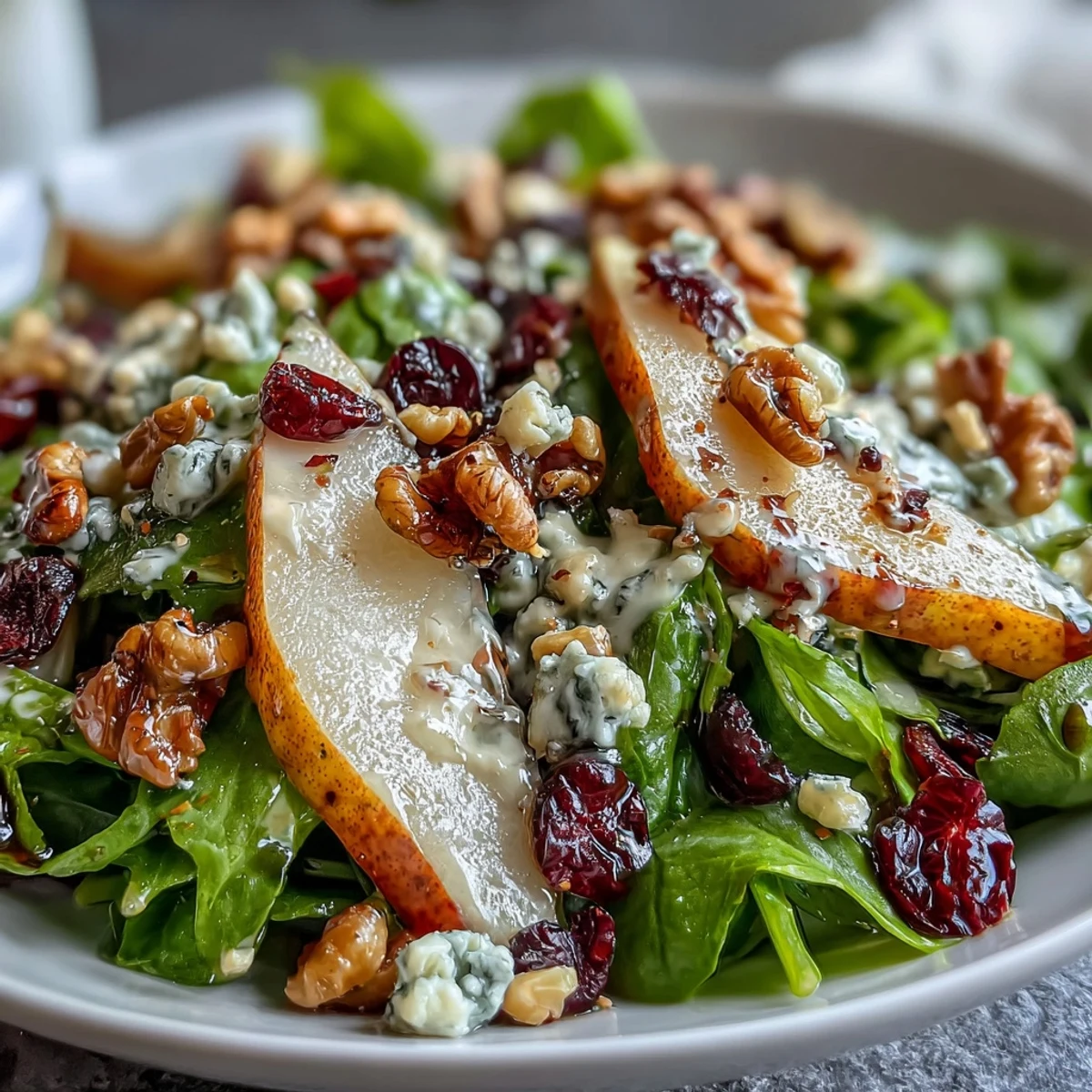 Fresh pear slices and crumbled Gorgonzola cheese on a bed of mixed greens with toasted walnuts, drizzled with honey-balsamic vinaigrette.