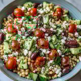 Cooled toasted pearl couscous tossed with feta, parsley, and a zesty oregano vinaigrette, served as a vibrant vegetarian lunch.