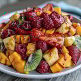 Colorful display of fresh mango, pineapple, and assorted tropical fruits, perfect for festive gatherings and brunches.