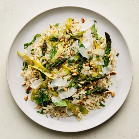 Shaved asparagus ribbons and tender orzo pasta tossed in a zesty lemon-olive oil dressing, topped with freshly grated Parmesan and pine nuts.  