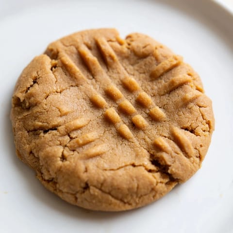 Chewy flourless peanut butter cookies drizzled with melty chocolate chips, a delicious dessert.