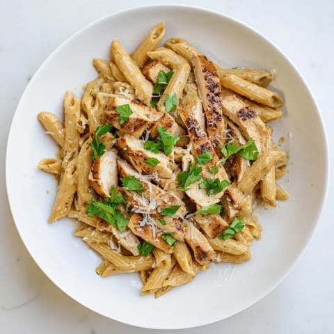 Sweet and smoky honey chipotle sauce coats penne pasta and sliced chicken in this dish.