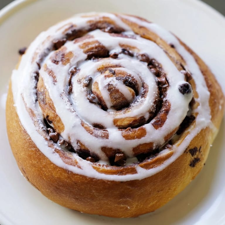 Spirals of soft dough filled with Nutella and mini chocolate chips, creating the perfect decadent breakfast treat for sharing.