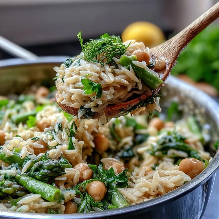 Bright and fresh one-pot lemon herb orzo featuring tender spring veggies, protein-rich chickpeas, and a burst of citrus flavor in every bite.