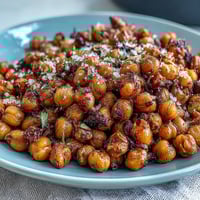 Crispy baked chickpeas seasoned with smoky paprika, cumin, and garlic for a crunchy, flavorful snack.  