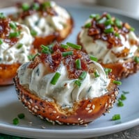 Everything Bagel Deviled Eggs topped with savory seasoning and cream cheese.